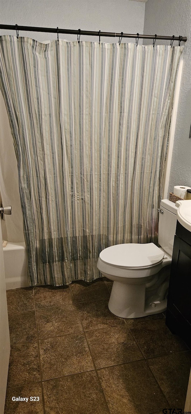 full bathroom featuring vanity, shower / bathtub combination with curtain, and toilet