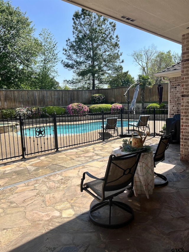 view of patio featuring fence and a fenced in pool