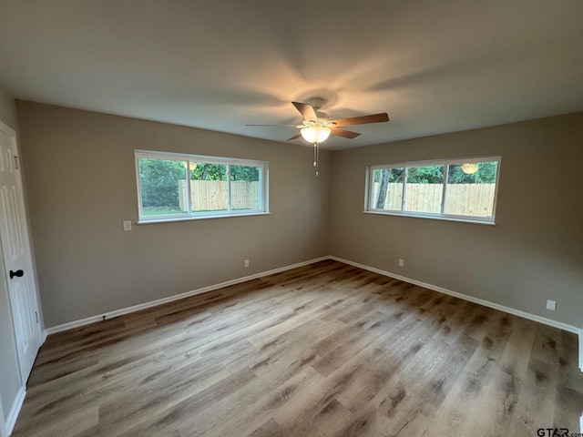 625 Northcrest Dr, Tyler, TX 75702 - empty room with plenty of natural light, a ceiling fan, and wood finished floors
