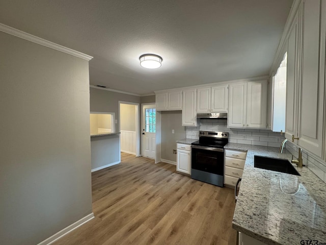 625 Northcrest Dr, Tyler, TX 75702 - kitchen featuring electric stove, ornamental molding, under cabinet range hood, white cabinets, and light wood-type flooring
