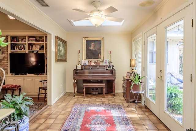3805 Allendale Dr, Tyler, TX 75701 - living area with ceiling fan, ornamental molding, a skylight, and light tile patterned floors