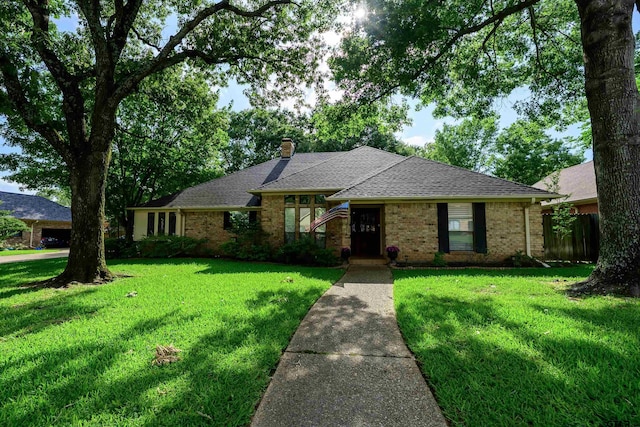 3805 Allendale Dr, Tyler, TX 75701 - view of front facade with a front yard, brick siding, and a chimney