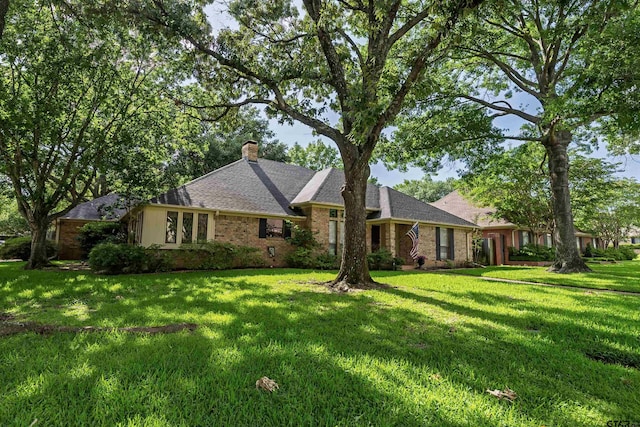 3805 Allendale Dr, Tyler, TX 75701 - view of front of home featuring a chimney, a front lawn, and brick siding
