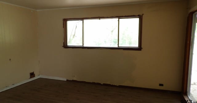 915 John St, Jacksonville, TX 75766 - empty room featuring wood finished floors, crown molding, and baseboards