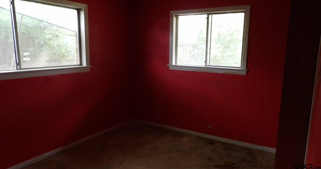 915 John St, Jacksonville, TX 75766 - spare room featuring baseboards and carpet