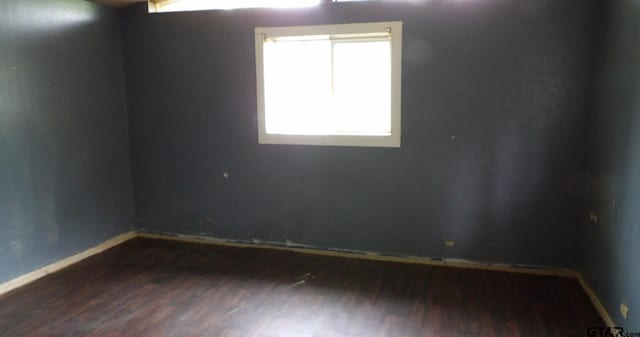 915 John St, Jacksonville, TX 75766 - spare room featuring wood finished floors and baseboards