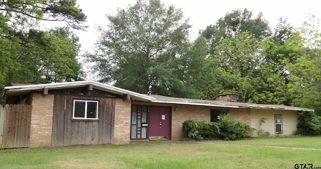 915 John St, Jacksonville, TX 75766 - view of front of house with a front lawn and a chimney