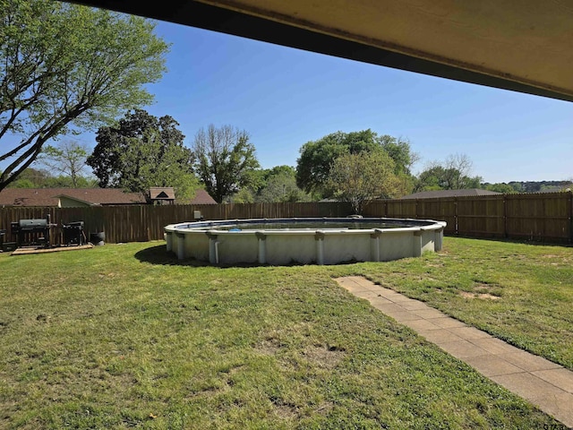 view of yard featuring a fenced in pool and a fenced backyard