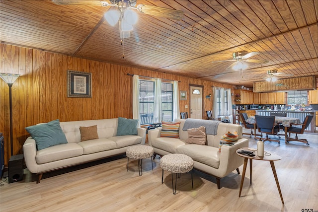 living area with a wealth of natural light, light wood-style floors, and ceiling fan