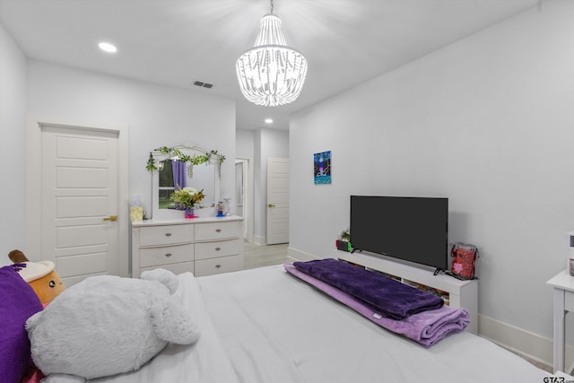 bedroom with light wood-type flooring and an inviting chandelier