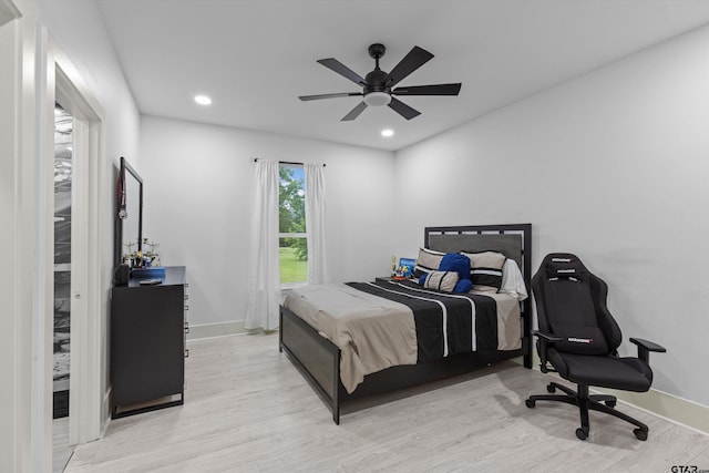 bedroom featuring ceiling fan and light hardwood / wood-style flooring