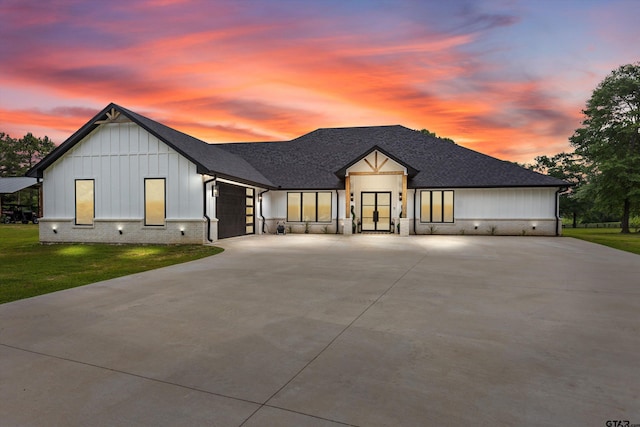 modern farmhouse style home with a yard