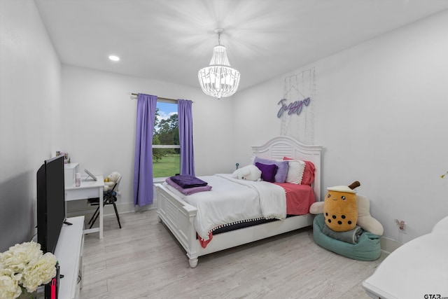 bedroom featuring a chandelier and light wood-type flooring