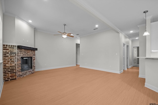 unfurnished living room featuring ornamental molding, a fireplace, light hardwood / wood-style flooring, and ceiling fan