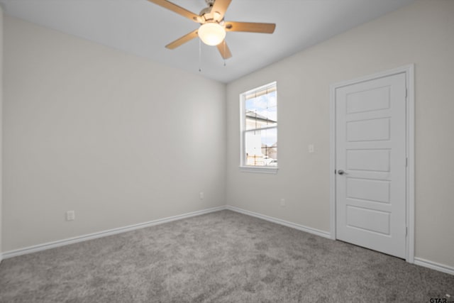 empty room featuring light colored carpet and ceiling fan