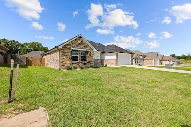 view of front of house with a garage and a front lawn