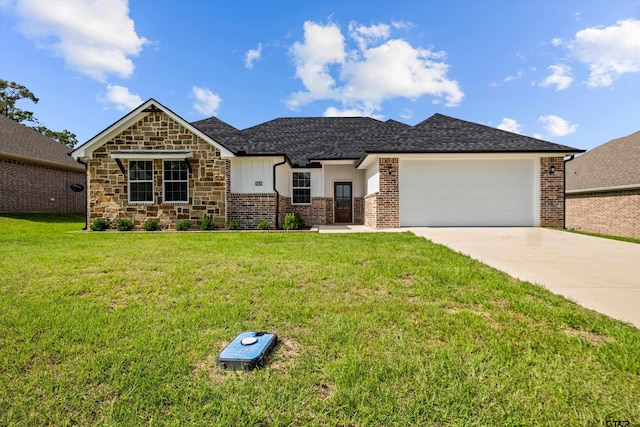 view of front facade with a garage and a front lawn