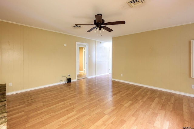 spare room featuring ceiling fan, ornamental molding, and light wood-type flooring