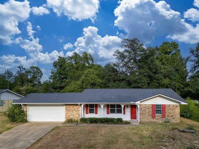 ranch-style home with a garage and a front lawn