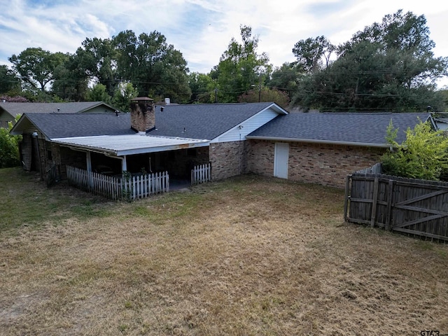 back of property with a lawn