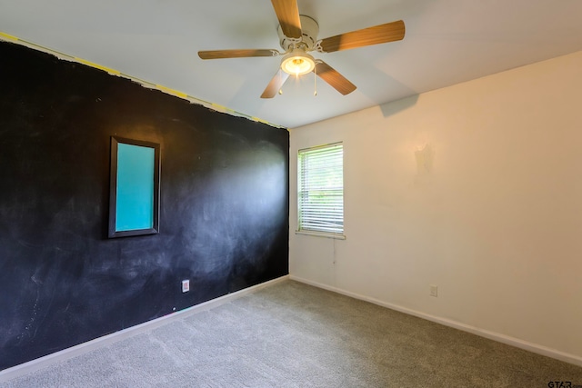 spare room featuring ceiling fan and carpet flooring