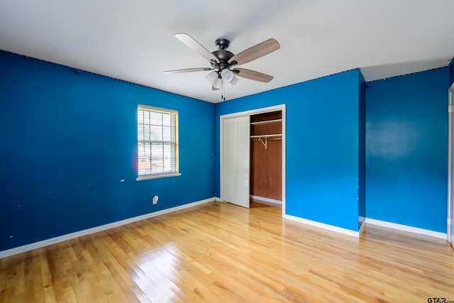 unfurnished bedroom with hardwood / wood-style floors, a closet, and ceiling fan