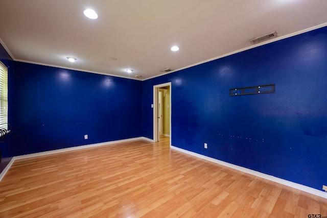 unfurnished room featuring light hardwood / wood-style floors and ornamental molding