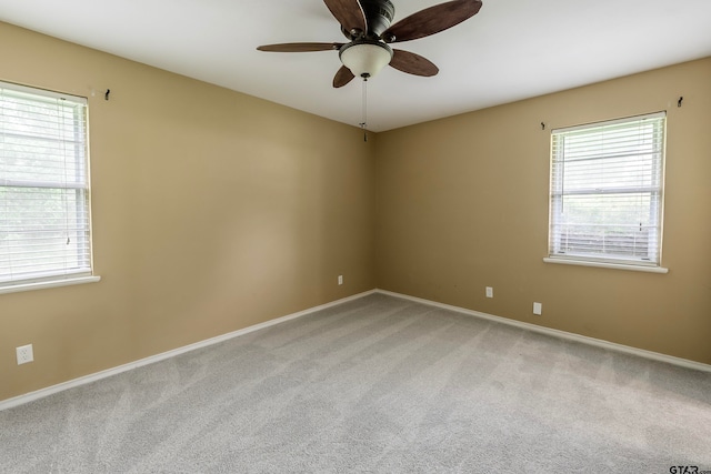 spare room with ceiling fan and light carpet