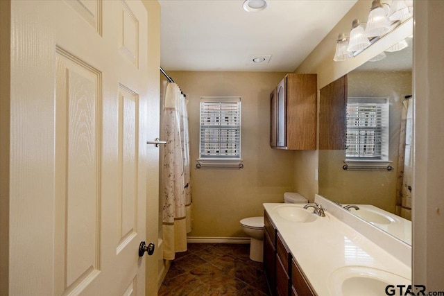 bathroom featuring tile patterned flooring, vanity, and toilet