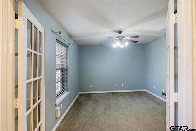 empty room featuring ceiling fan and carpet floors