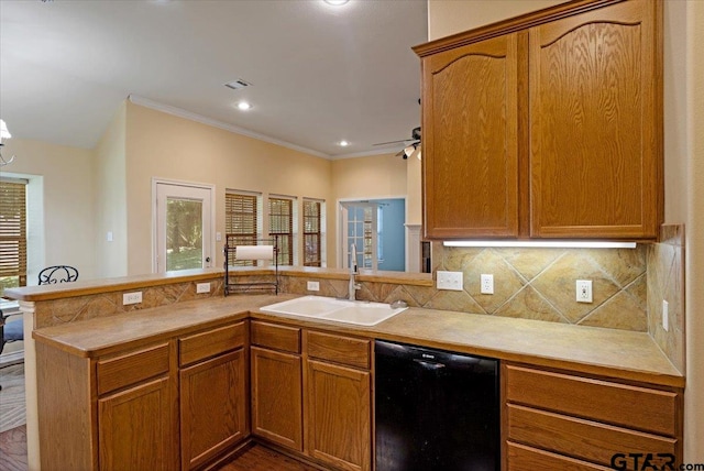 kitchen with black dishwasher, kitchen peninsula, a healthy amount of sunlight, and sink