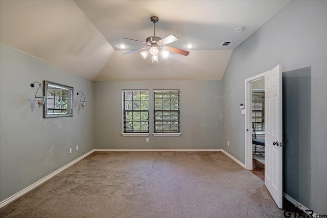 unfurnished bedroom featuring ceiling fan, carpet flooring, and vaulted ceiling