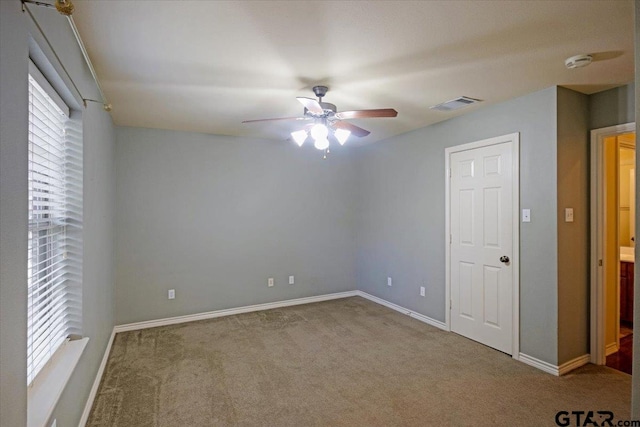 unfurnished bedroom featuring ceiling fan and carpet floors