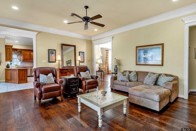 living room with dark wood-type flooring, ceiling fan, and ornamental molding