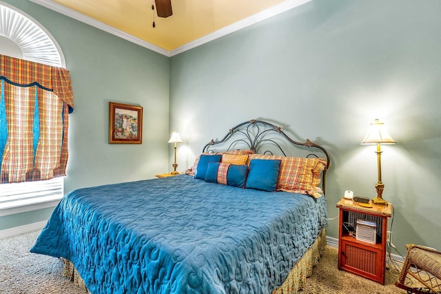 carpeted bedroom with ornamental molding and ceiling fan