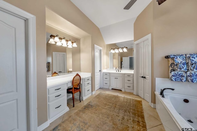 bathroom with vanity, vaulted ceiling, tile patterned flooring, a washtub, and ceiling fan