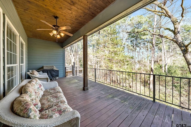 deck with a grill and ceiling fan