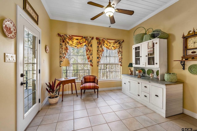 living area with ceiling fan, light tile patterned floors, wooden ceiling, and crown molding