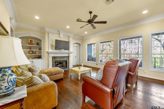 living room featuring dark hardwood / wood-style flooring, ceiling fan, a healthy amount of sunlight, and crown molding