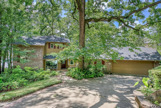 17553 Sleepy Hollow Way, Flint, TX 75762 - view of front facade featuring concrete driveway, an attached garage, brick siding, and roof with shingles