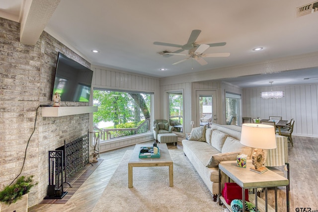 17553 Sleepy Hollow Way, Flint, TX 75762 - living room with wood finished floors, ceiling fan, a chandelier, a fireplace, and ornamental molding