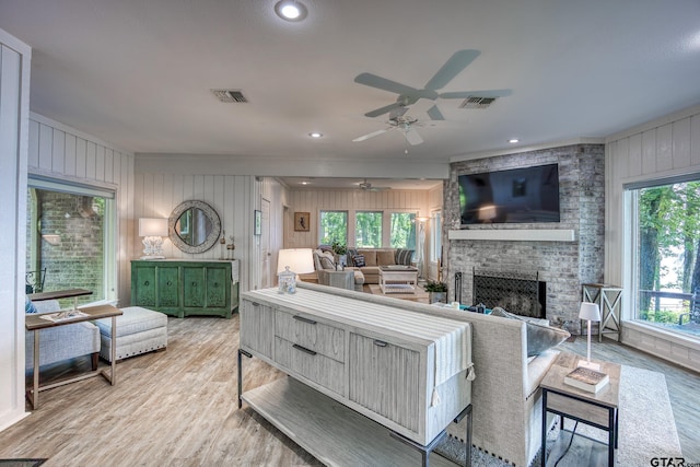 17553 Sleepy Hollow Way, Flint, TX 75762 - living area featuring a ceiling fan, light wood finished floors, a fireplace, wooden walls, and recessed lighting