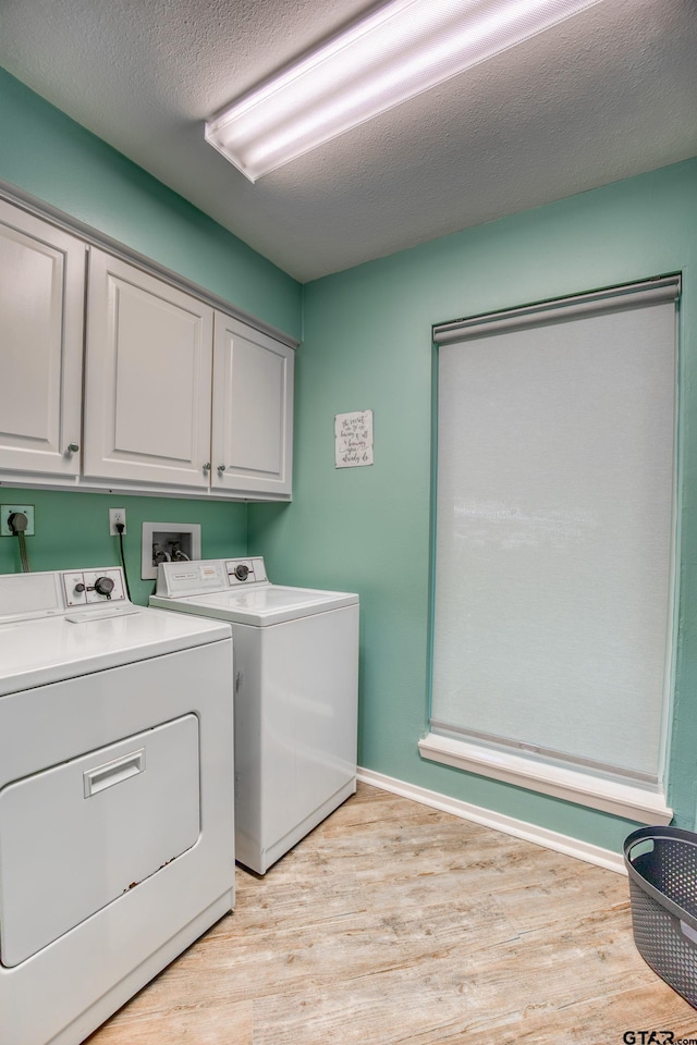 17553 Sleepy Hollow Way, Flint, TX 75762 - washroom featuring cabinet space, washer and dryer, light wood-style floors, a textured ceiling, and baseboards