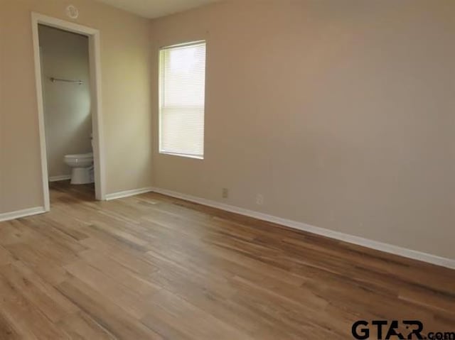 510EMMAST W Emma St, Bullard, TX 75757 - unfurnished bedroom with baseboards and light wood-type flooring