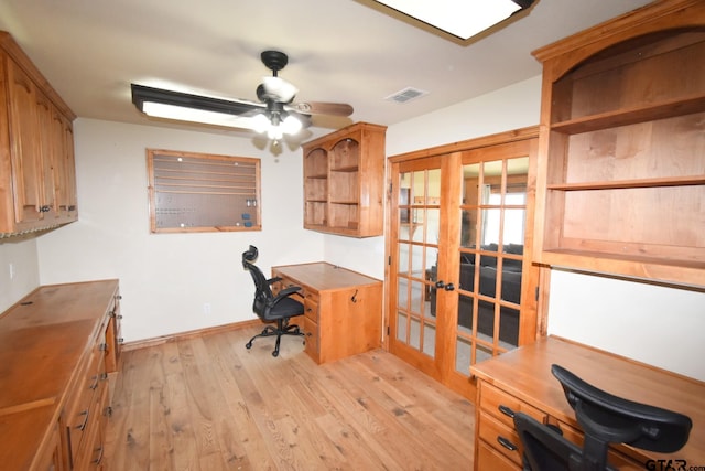 office with light hardwood / wood-style floors, french doors, and ceiling fan