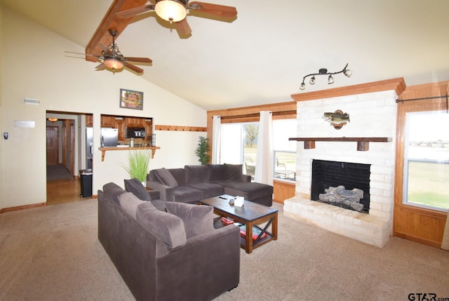 carpeted living room with a fireplace, high vaulted ceiling, and ceiling fan