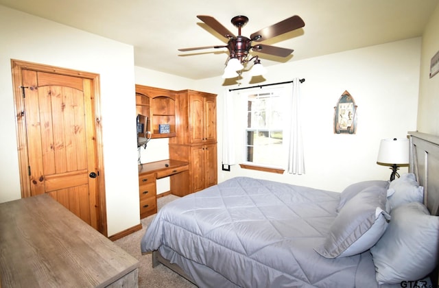 carpeted bedroom with ceiling fan