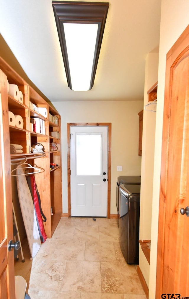 laundry room with washer and clothes dryer and cabinets