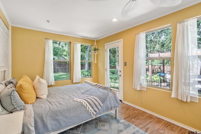 bedroom featuring access to exterior, ornamental molding, wood finished floors, baseboards, and recessed lighting