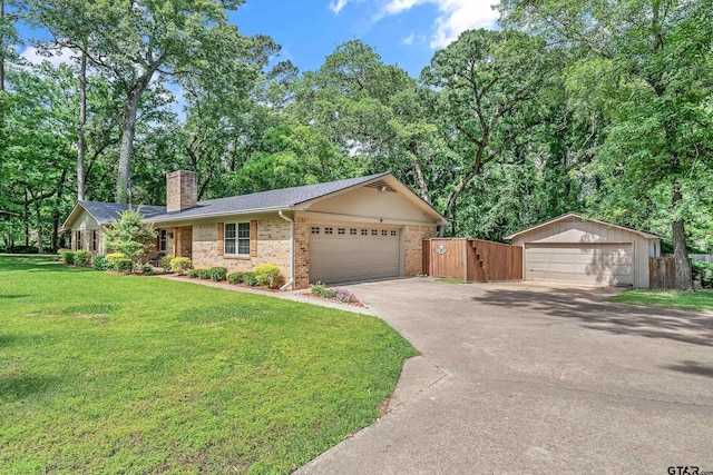 ranch-style home with brick siding, a chimney, and a detached garage
